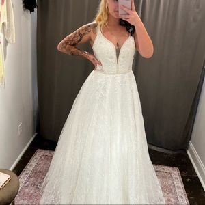 Size 14, never used wedding dress. Brand new.